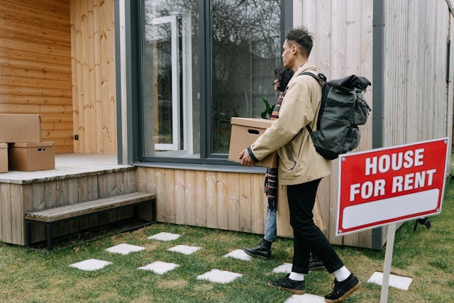 people walking being a house for rent sign