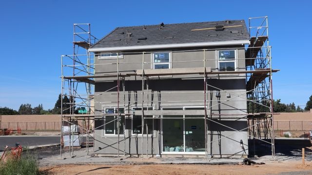 house surrounded by scaffolding