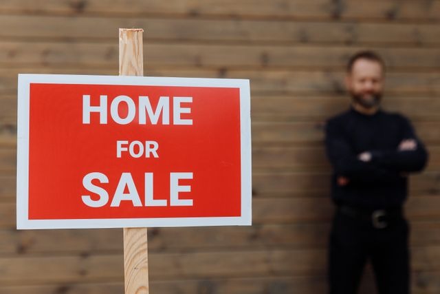 home for sale sign in front of property manager