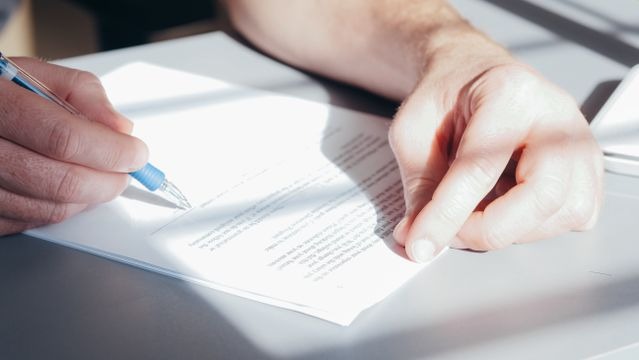 person signing a document