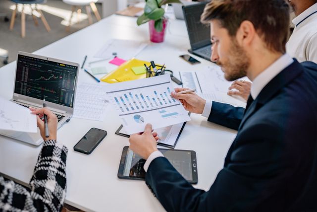 Business team reviewing graphs and data in an office setting