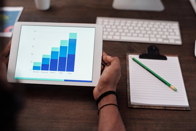 a person looking at a blue graph on a tablet