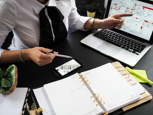 a real estate agent showing a property’s floor plan