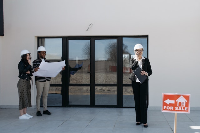 a realtor showing a new home to two prospective buyers