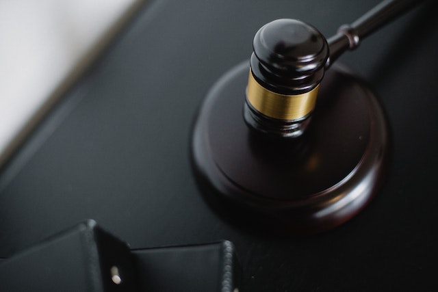 black and gold judges gavel on a desk