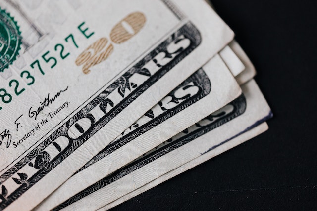 close-up of several 20 dollar bills stacked on each other