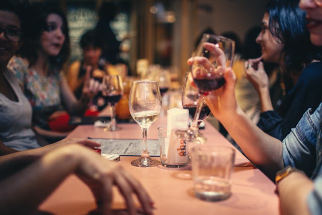group of people drinking wine at a table