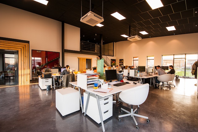 open concept office space with groupings of desks pushed together