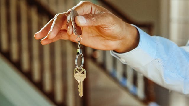 person holding up a set of keys 