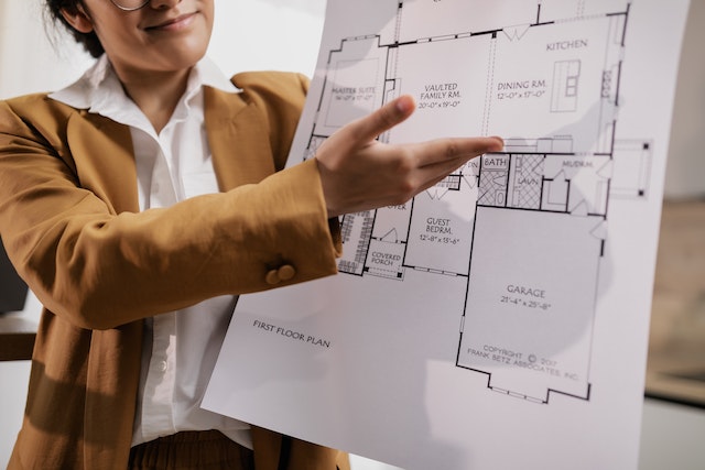person pointing to a section of homes blueprint