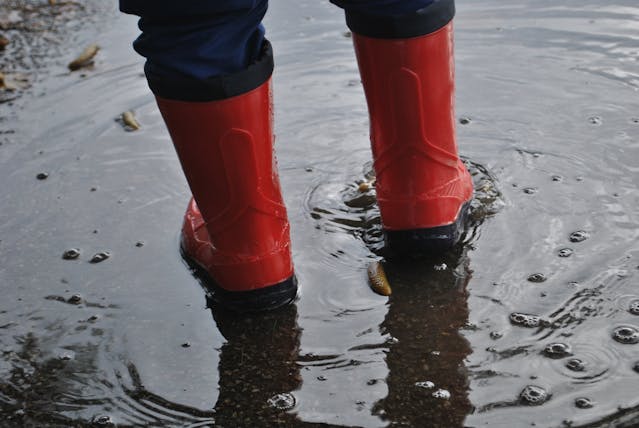 red rubber boots in puddle