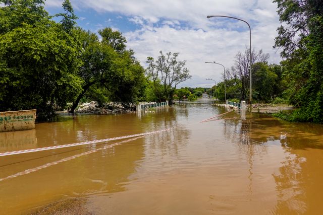 A flooded road with a submerged bridge
