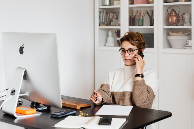 property owner sitting at their desk talking on the phone