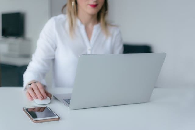 tenant in a white shirt making online requests on their laptop