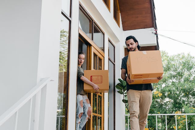 tenants carrying moving boxes out of the rental property