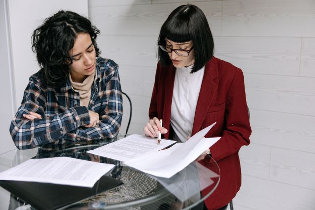 two people reviewing business documents