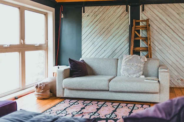 green living room with two white barn doors and a white two seater couch